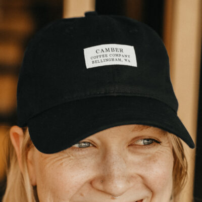 Girl wearing hat with Camber Coffee Company patch